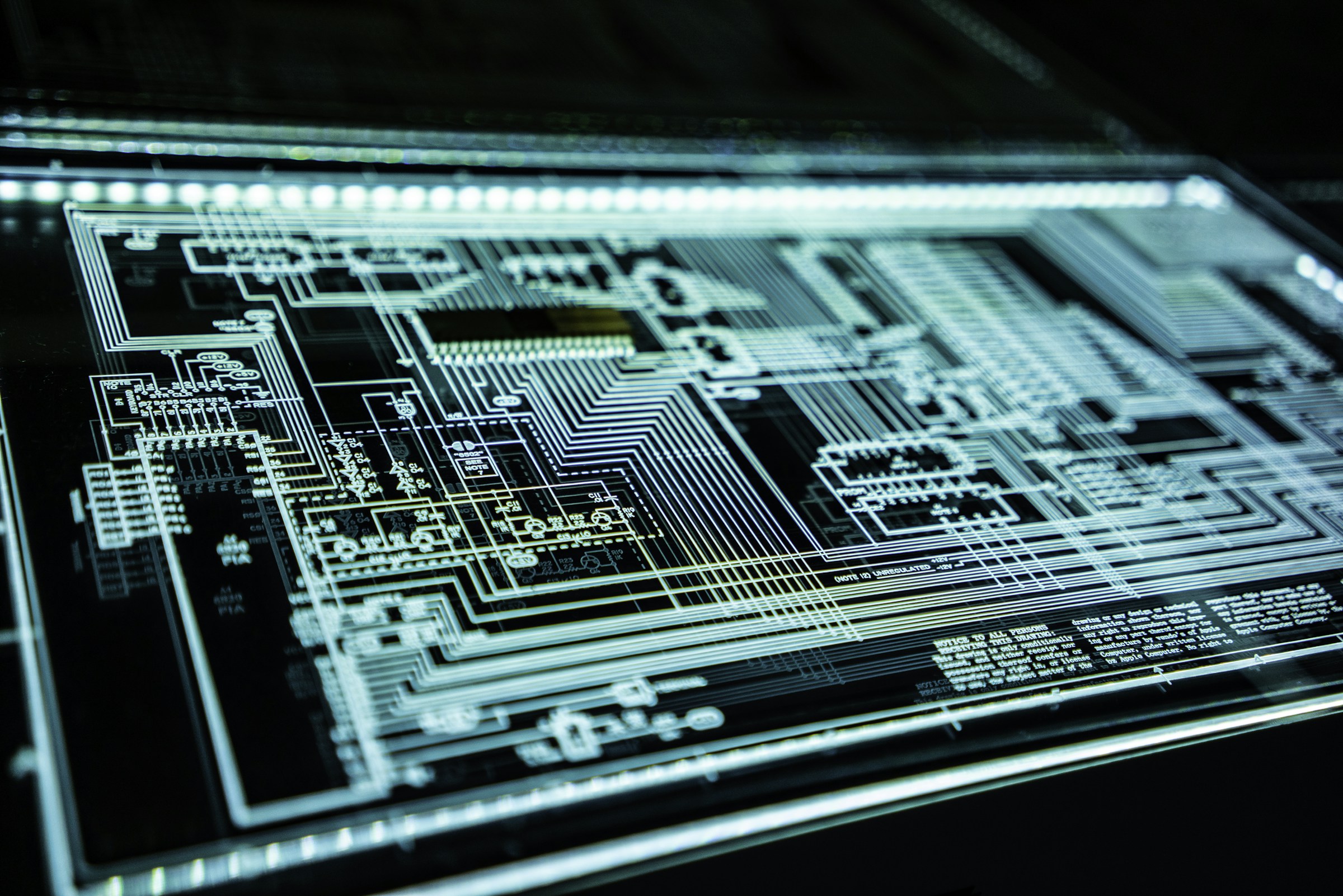 Cyan illuminated circuit schematic representing technical engineering and software architecture